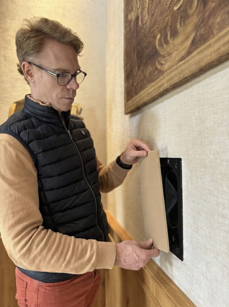 Audiovisual integrator installing invisible in wall speakers that blend in with your home decor.